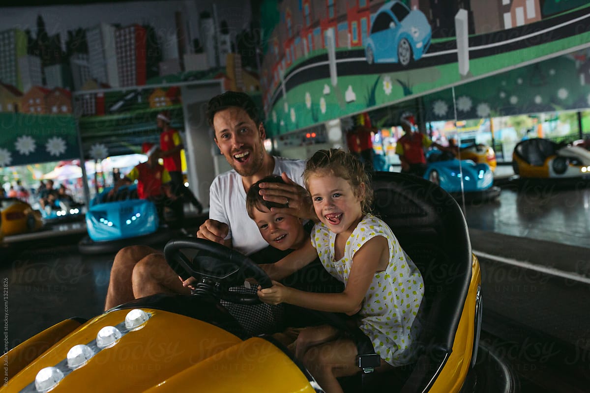 Dad and kids having fun on bumper cars
