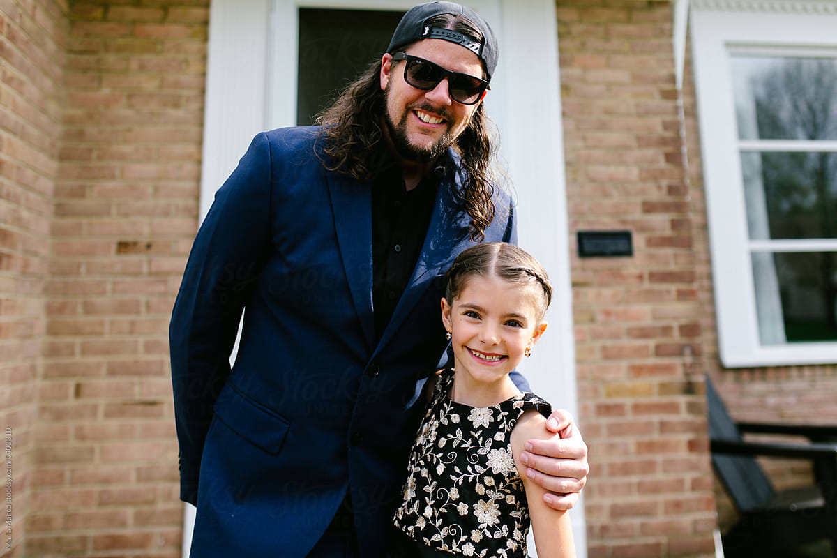 Father and Daughter pose for photos before dance