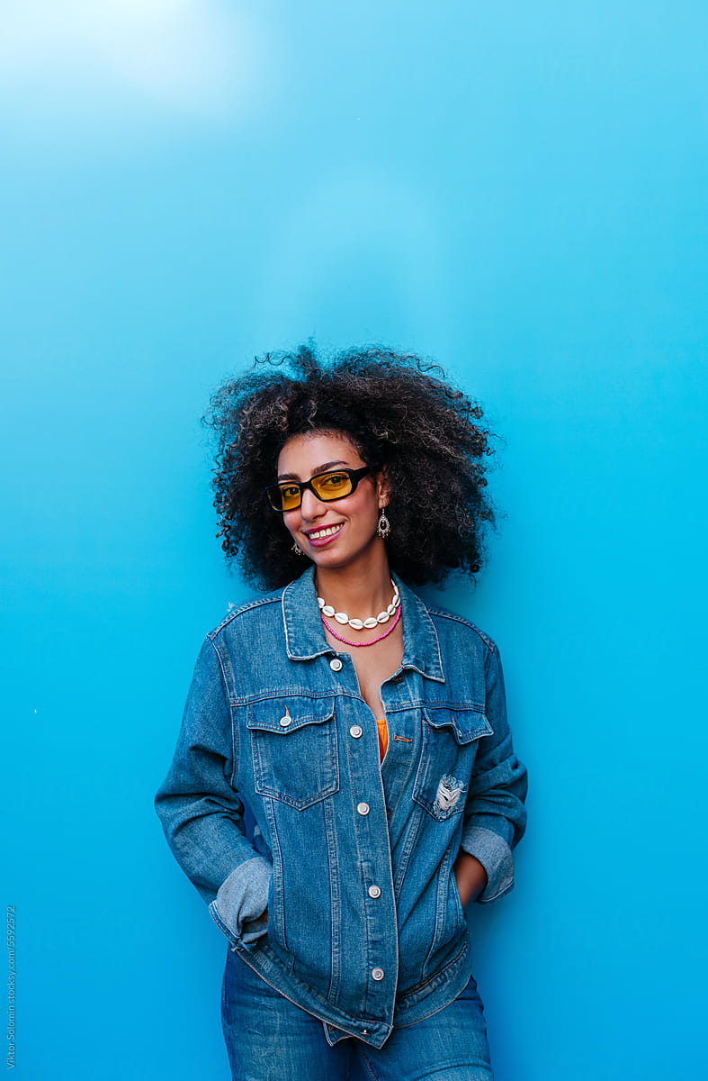 Stylish Egyptian woman with Afro haircut wearing denim outfit