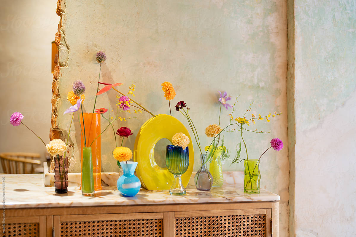 Counter with bohemian glass vases with flowers