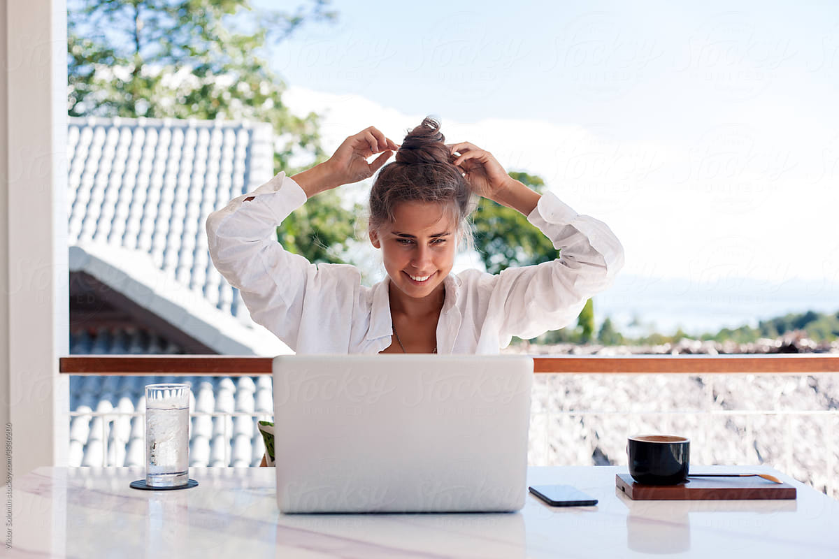Smiling woman working online with laptop
