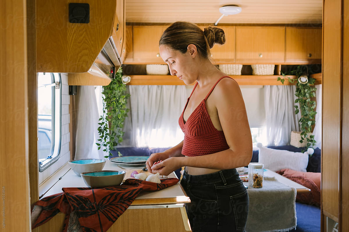 Woman cooking in a camper van