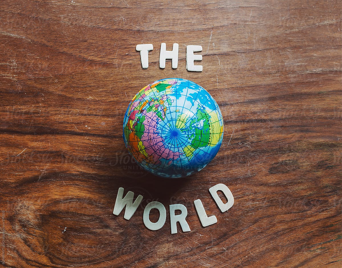 The world. Small globe on wooden background.