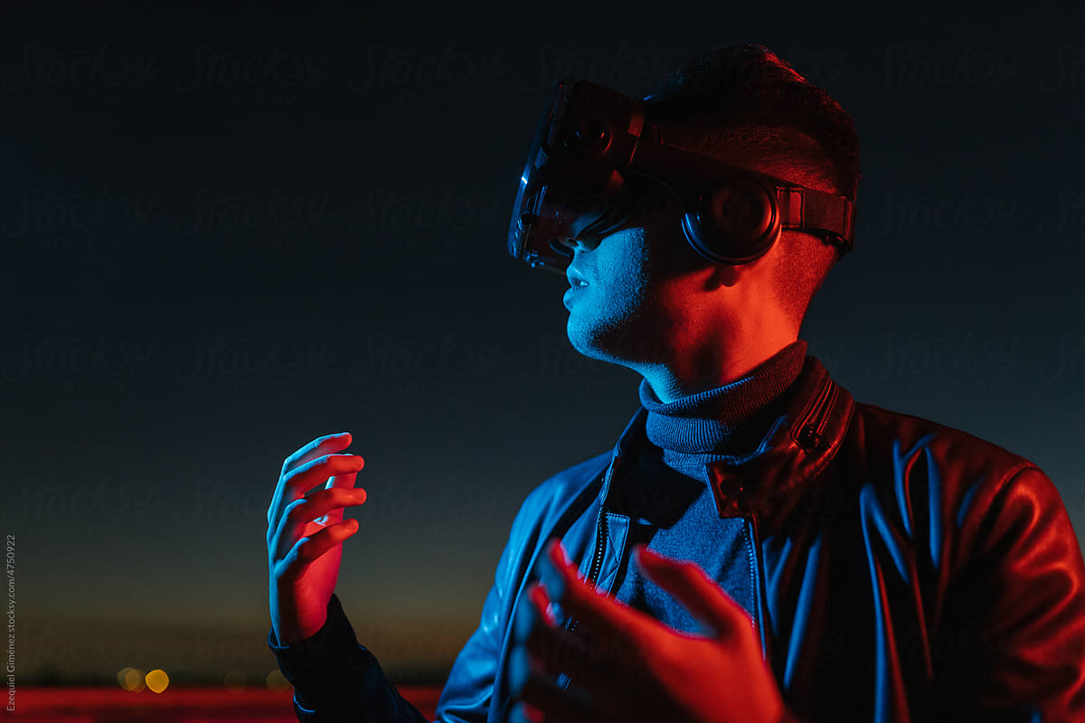 Astonished gamer exploring cyberspace in VR glasses