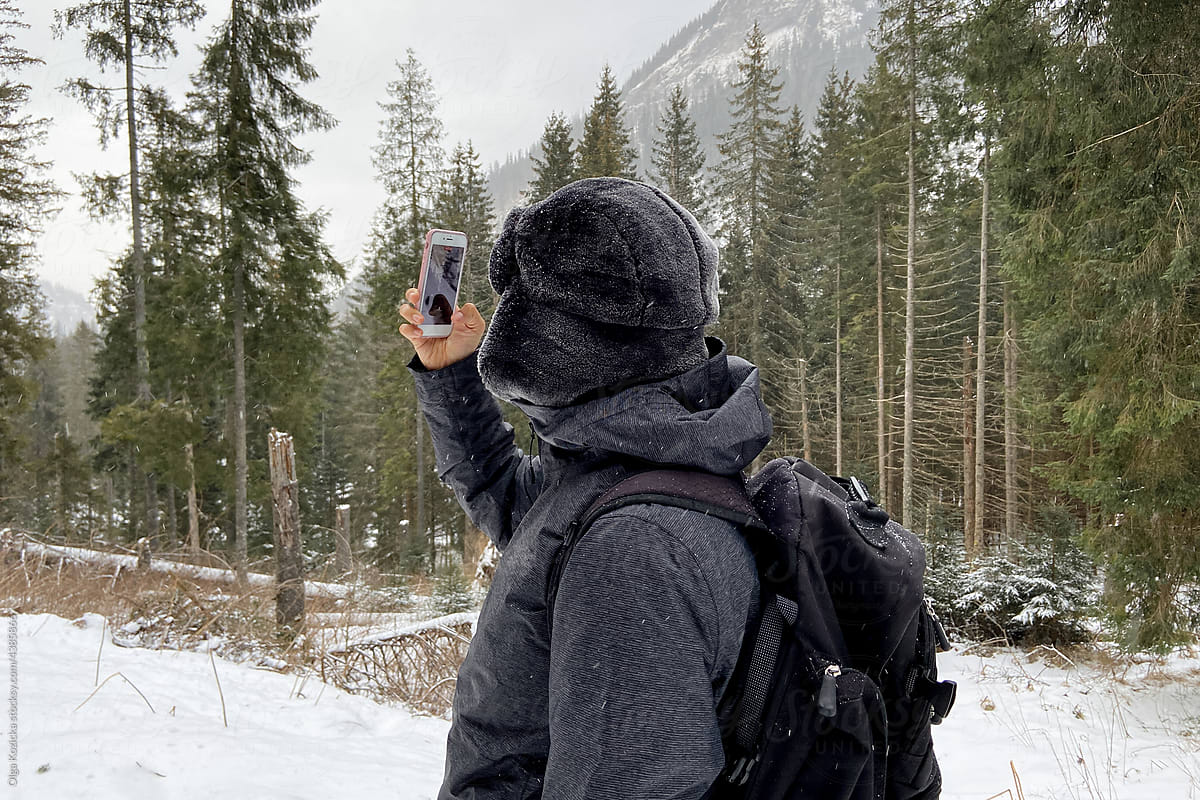 Woman Taking Photos In Winter Forest