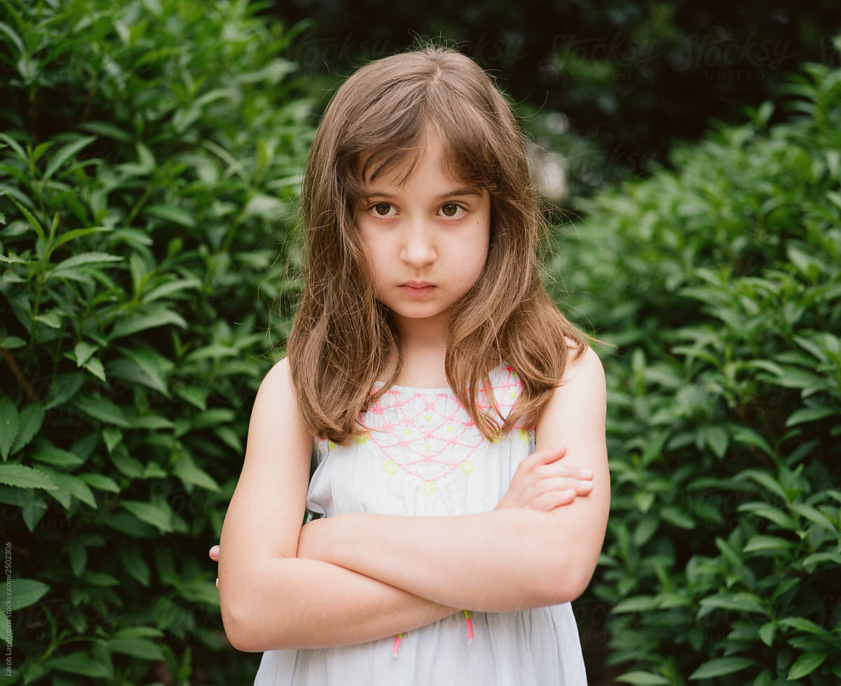 Moody Young Girl In A Dress Standing By A Pair Of Bushes Outside By Stocksy Contributor Jakob 4341