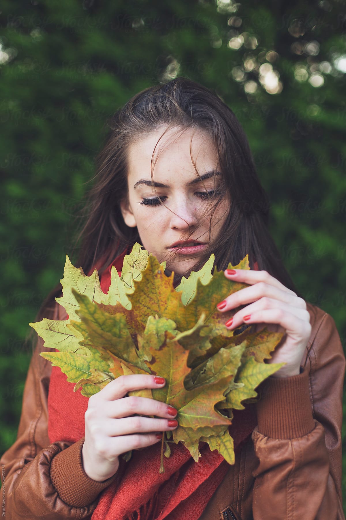 Young Teen Holding Bunch Of Maple Leafs by Dejan Ristovski