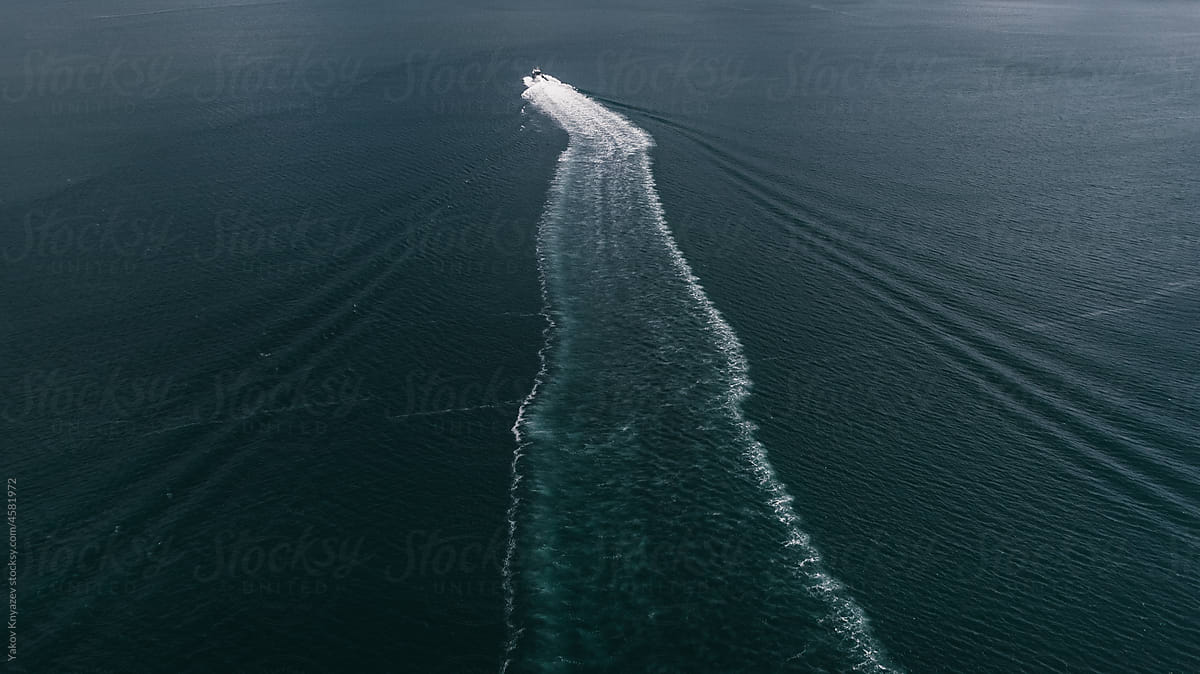 drone view of a speedboat in dark water