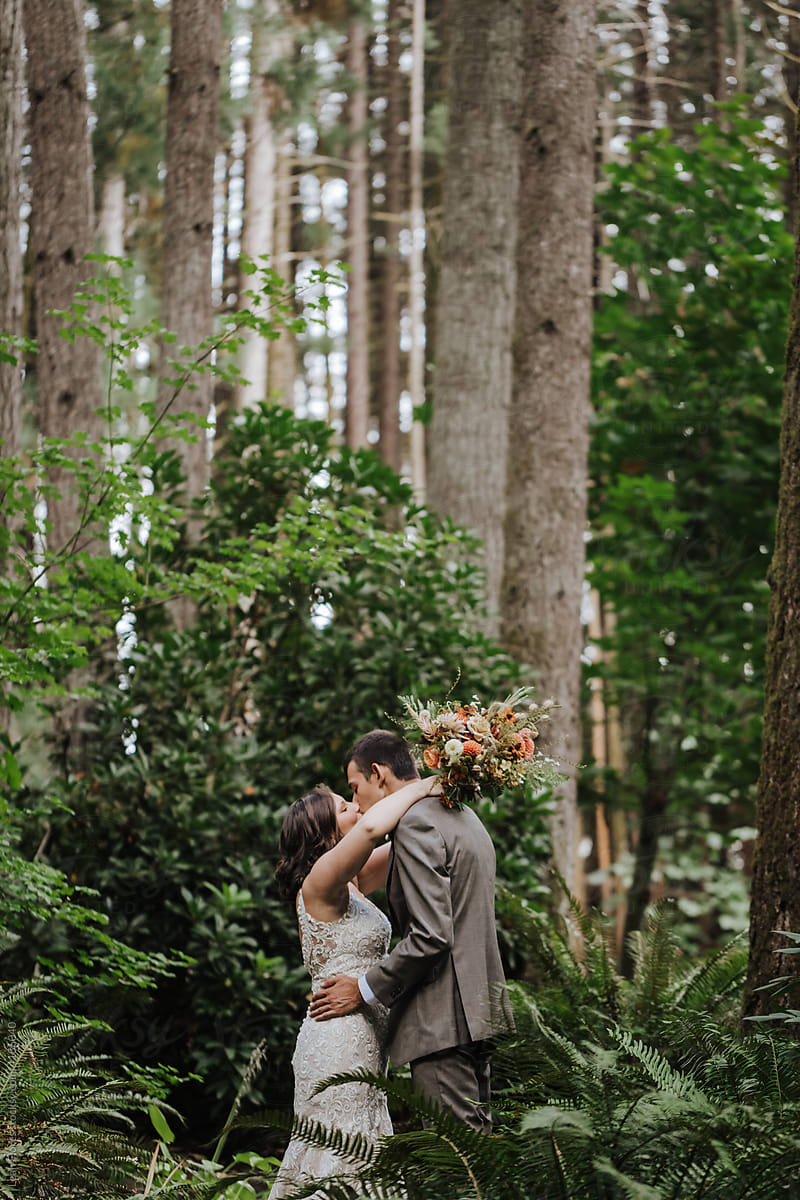 Bride and Groom Kissing in Trees and Ferns