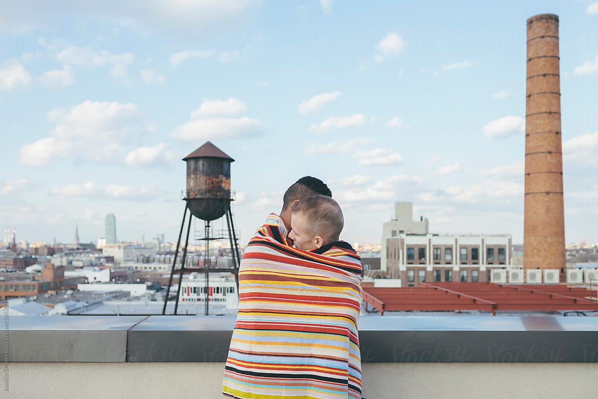 Portrait Of Loving Interracial Gay Male Couple Embracing On A Brooklyn Rooftop By Stocksy 