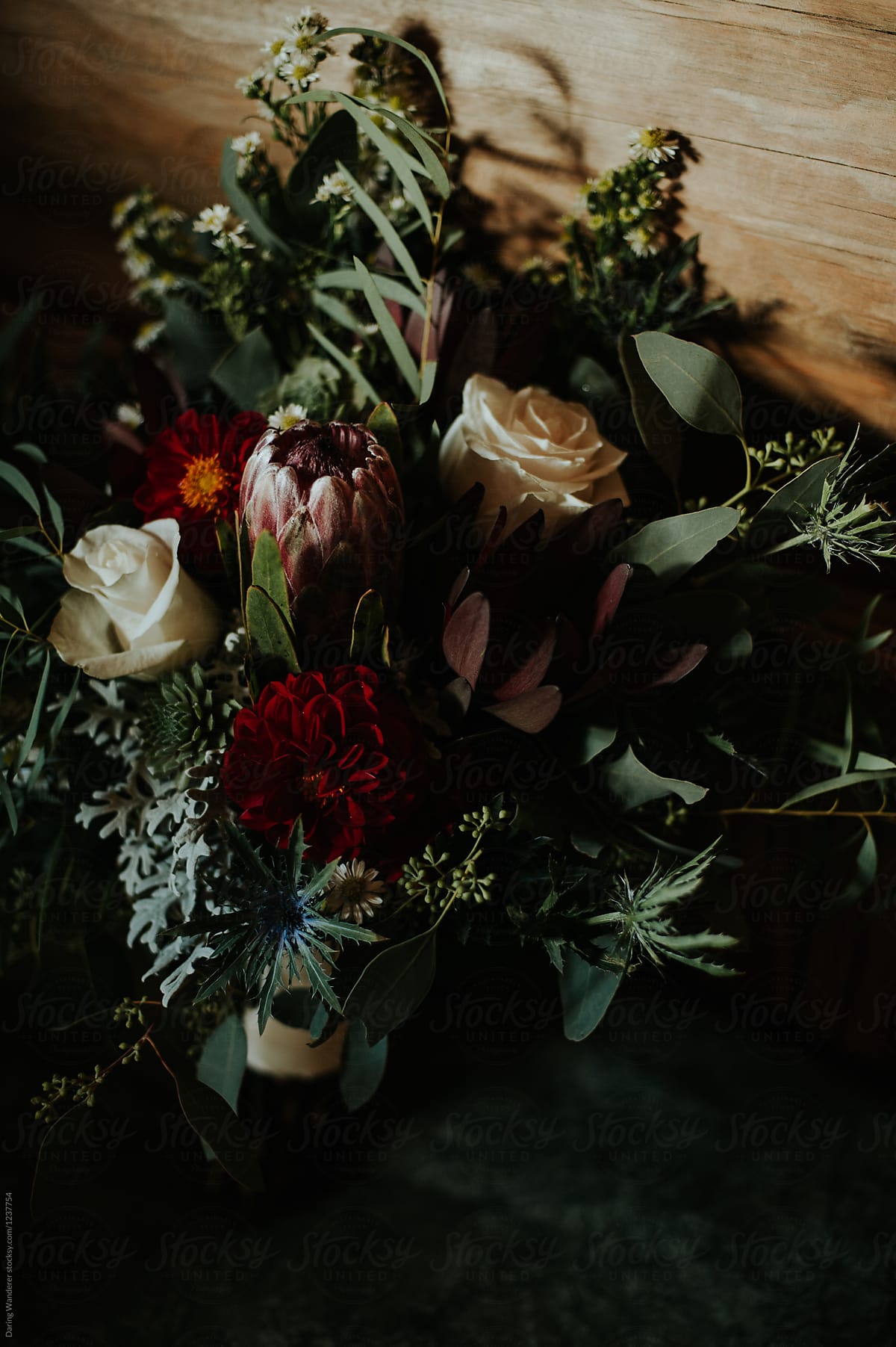 Moody protea and white rose wedding bouquet in log cabin