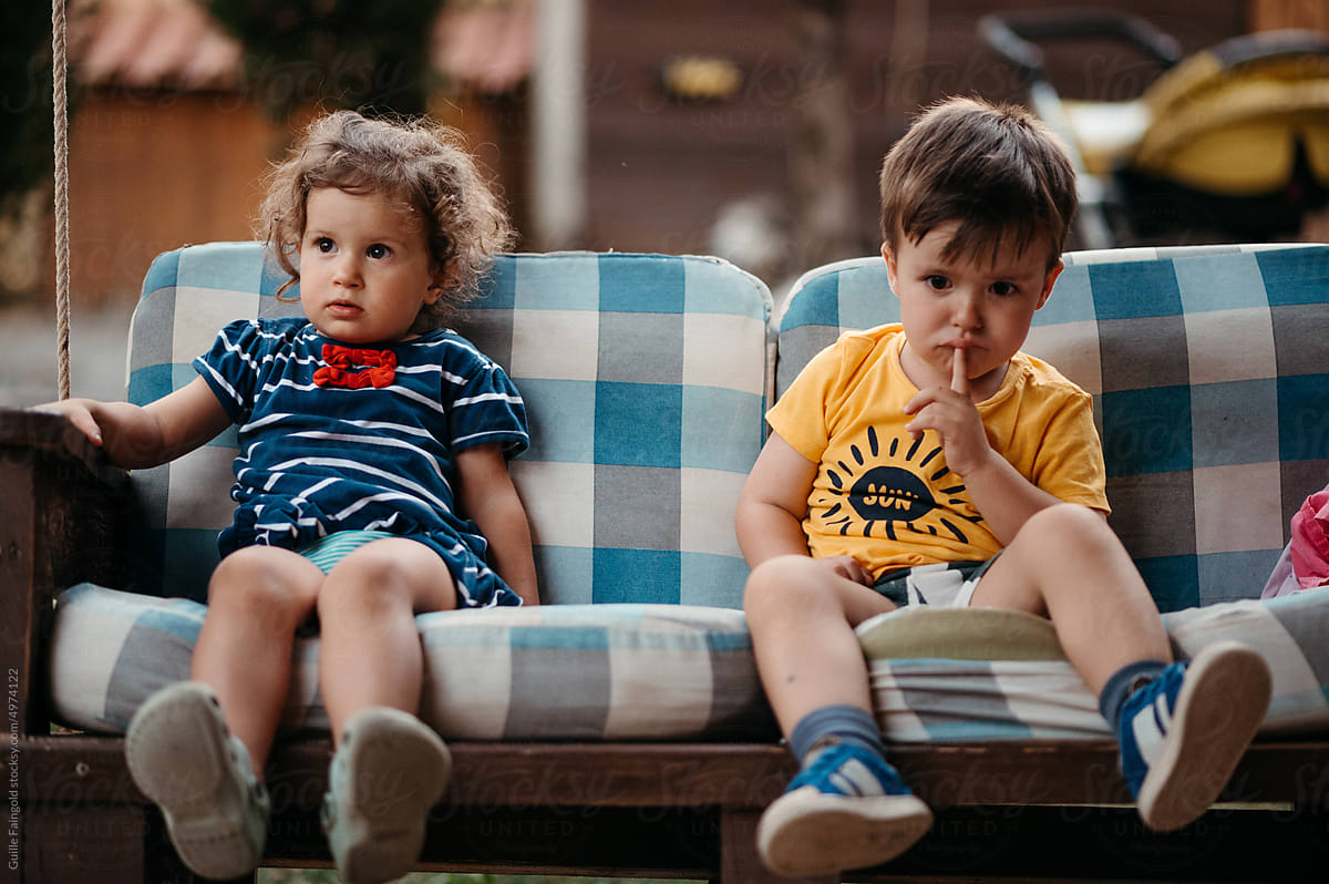 Siblings sitting on bench