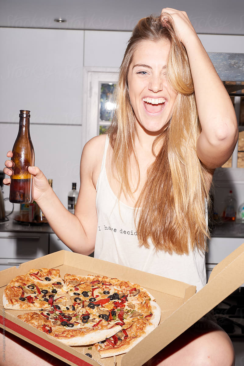 Girl enjoying pizza and beer