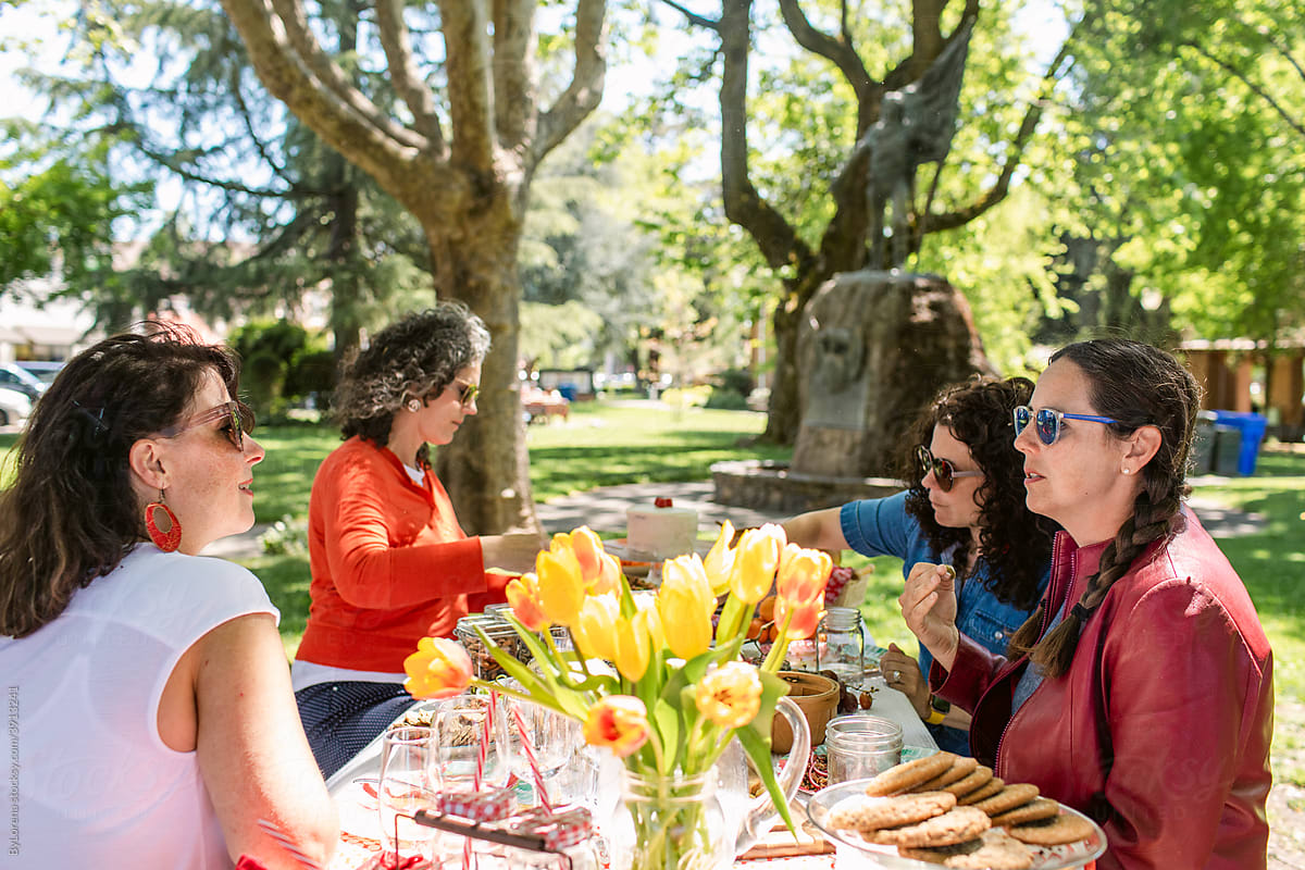 Group of women enjoying picnic in sunny park