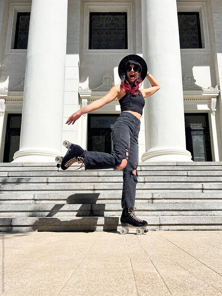 Woman Roller Skating in Black Hat & Ripped Jeans