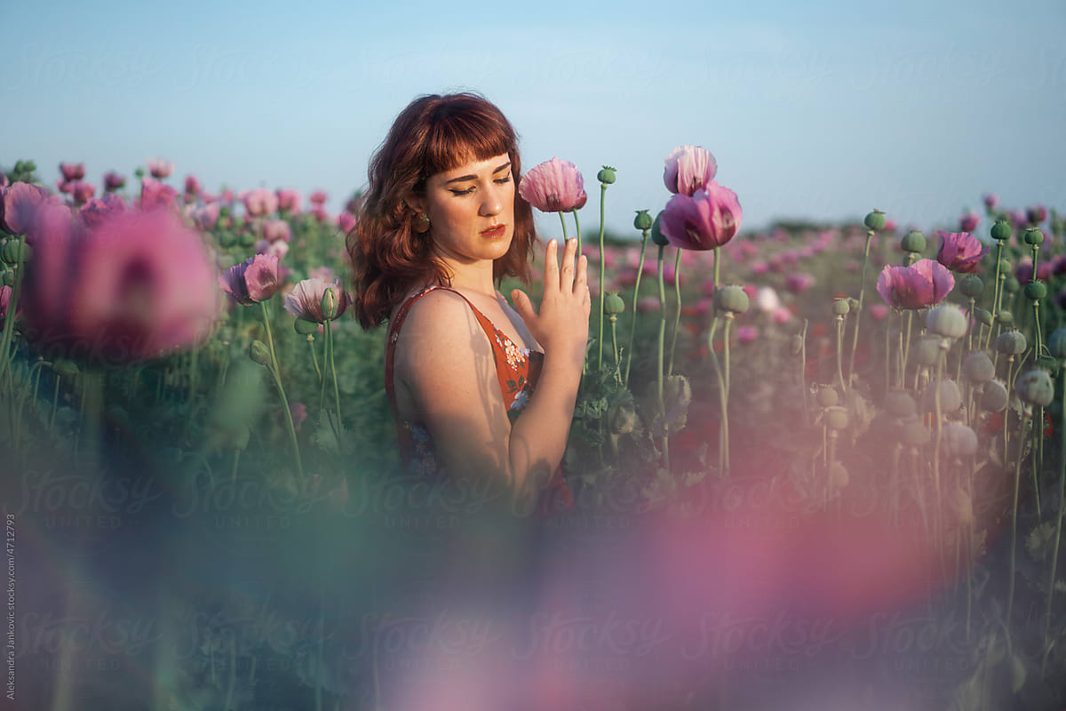 Dreamy Portrait Of A Redhead Woman In The Poppy Seed Flower Field