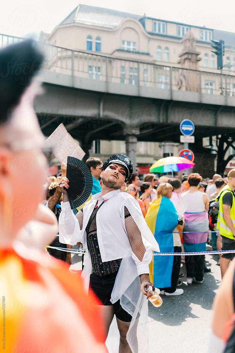 Man in shiny police hat posing for photos at a Pride