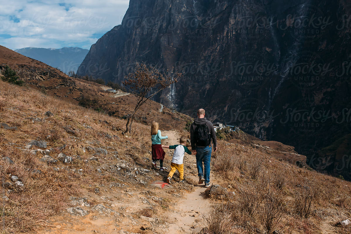 Back view of a family hiking in the mountains