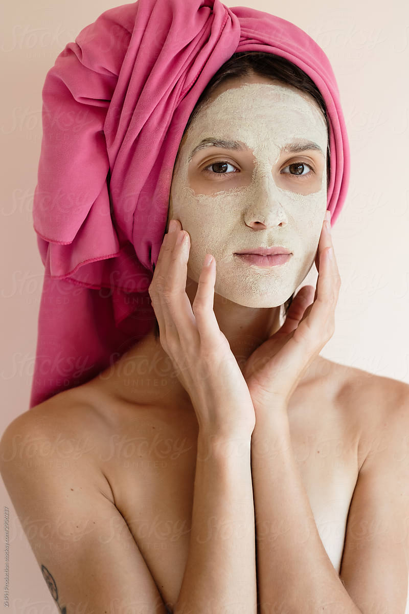 Woman applying clay beauty mask