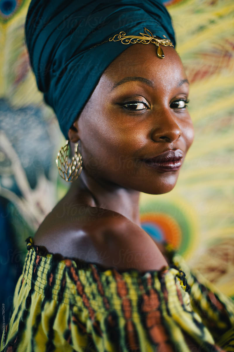 Beautiful african hippie portrait in yellow dress and blue turban