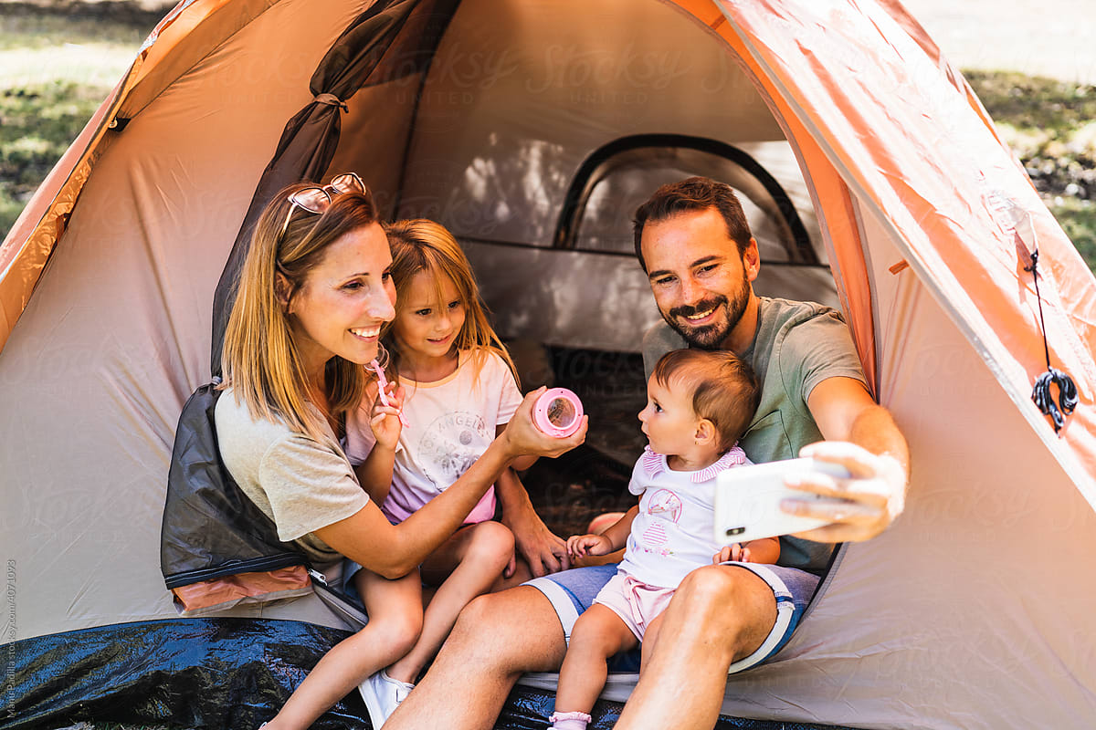Family taking selfie on campsite together