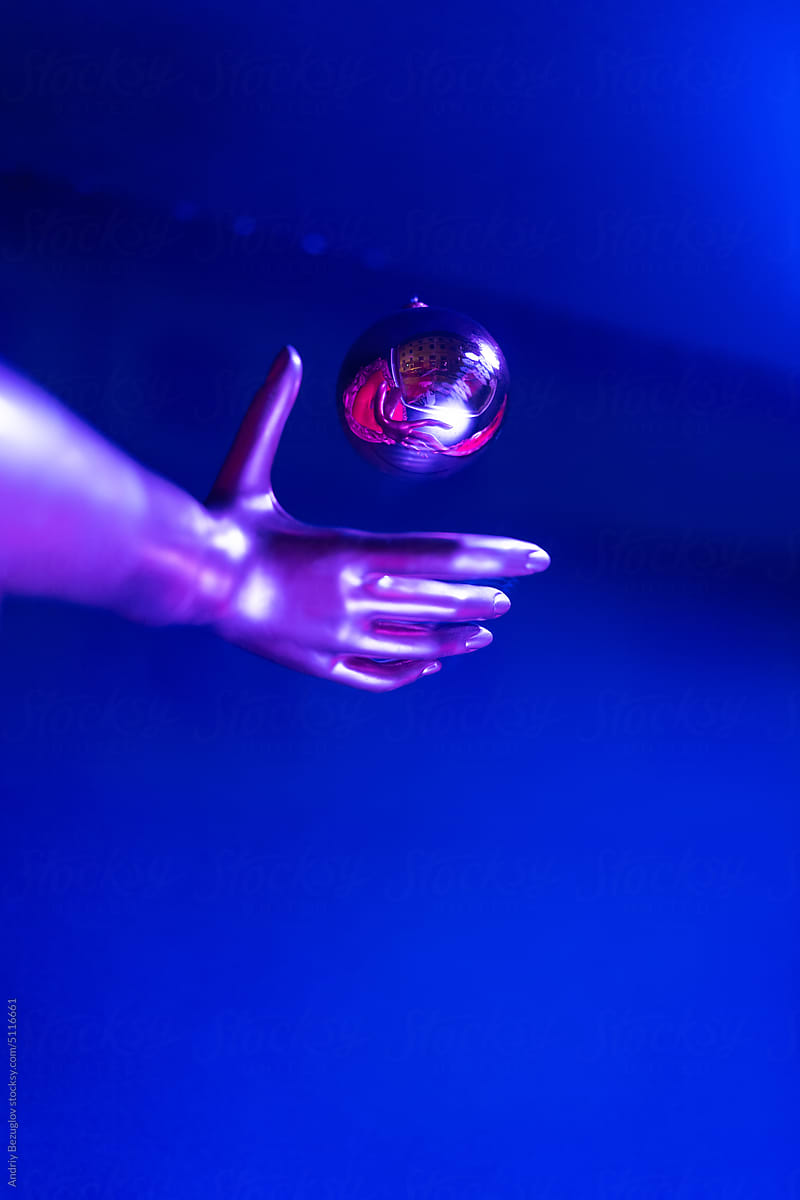 Colorful concept of dummy\'s hand with glass ball