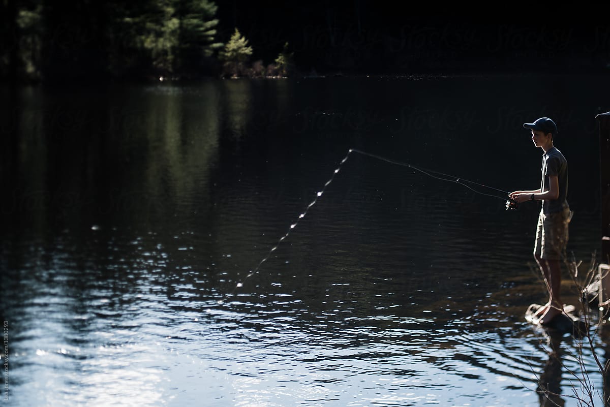 Teen Boy Fishing On Lake by Stocksy Contributor Lea Jones - Stocksy