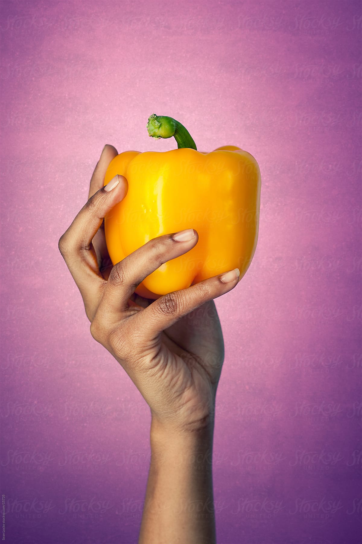 Healthy:Woman Holds Whole Yellow Pepper