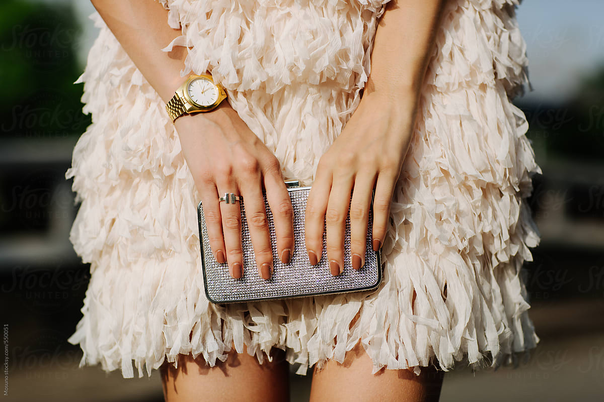 AI generated a woman's hand holding a trendy clutch bag with a bold print  35592586 Stock Photo at Vecteezy
