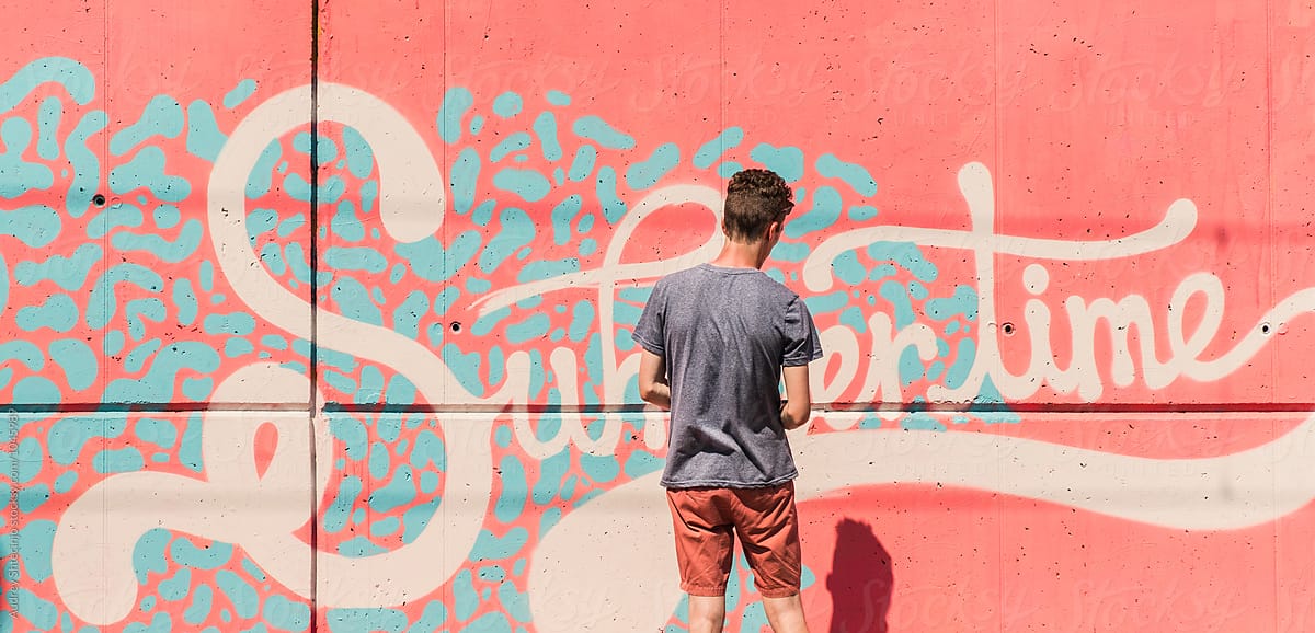 "Graffiti artist working on "Summertime" graffiti/mural " by Stocksy Contributor "AUDSHULE"