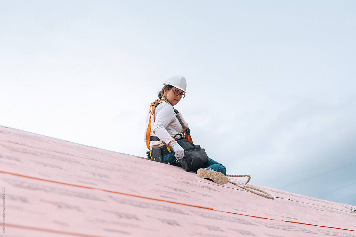 Woman roofer working on sustainable roof