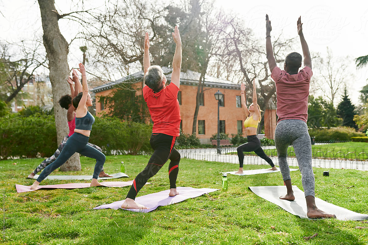 Students practicing yoga in a park