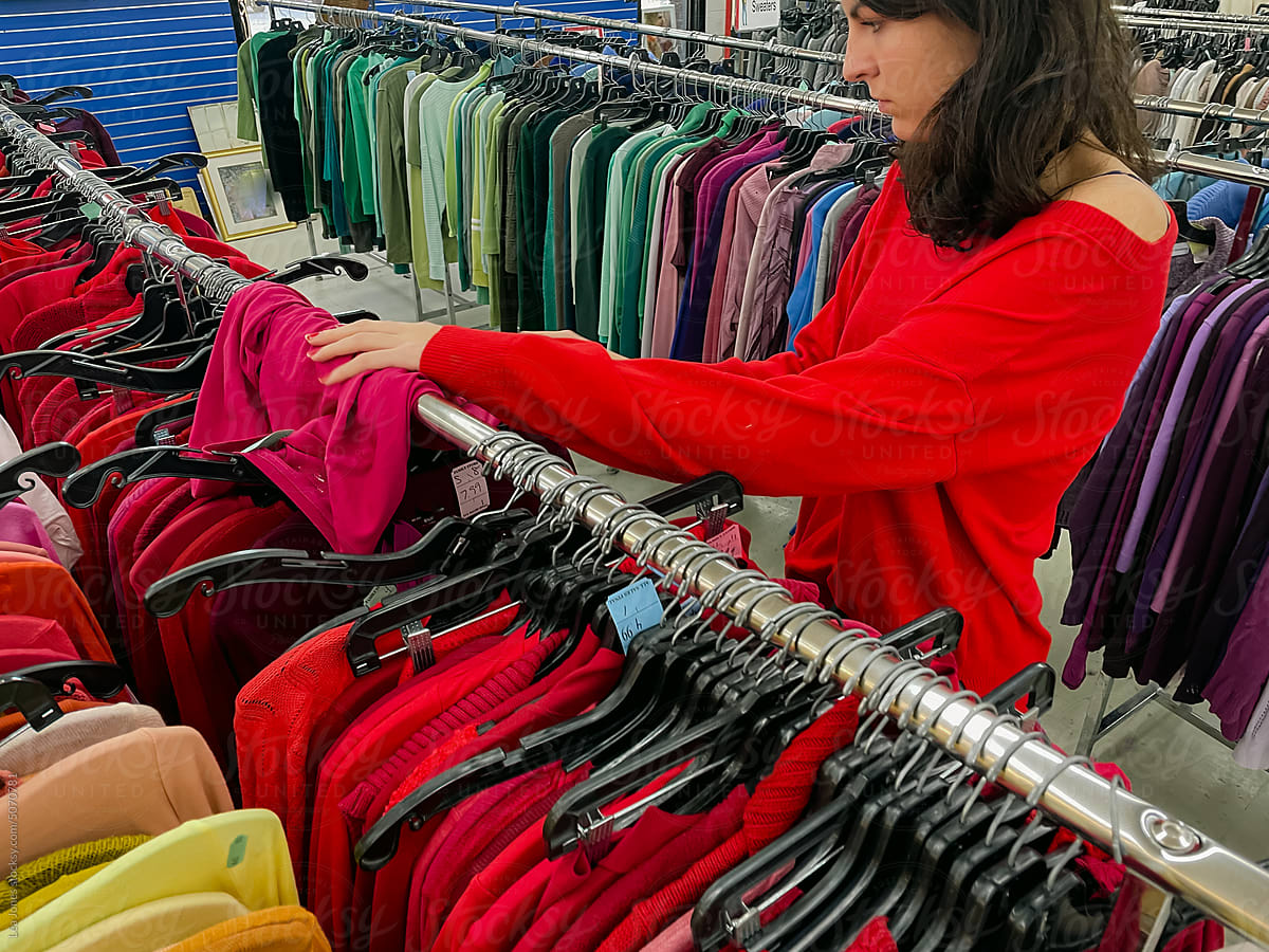 woman looking at clothes  thrift store