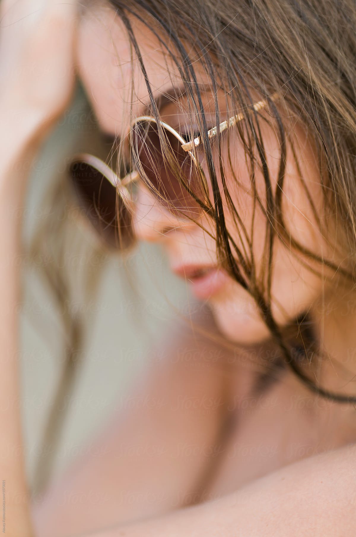young woman with round sunglasses