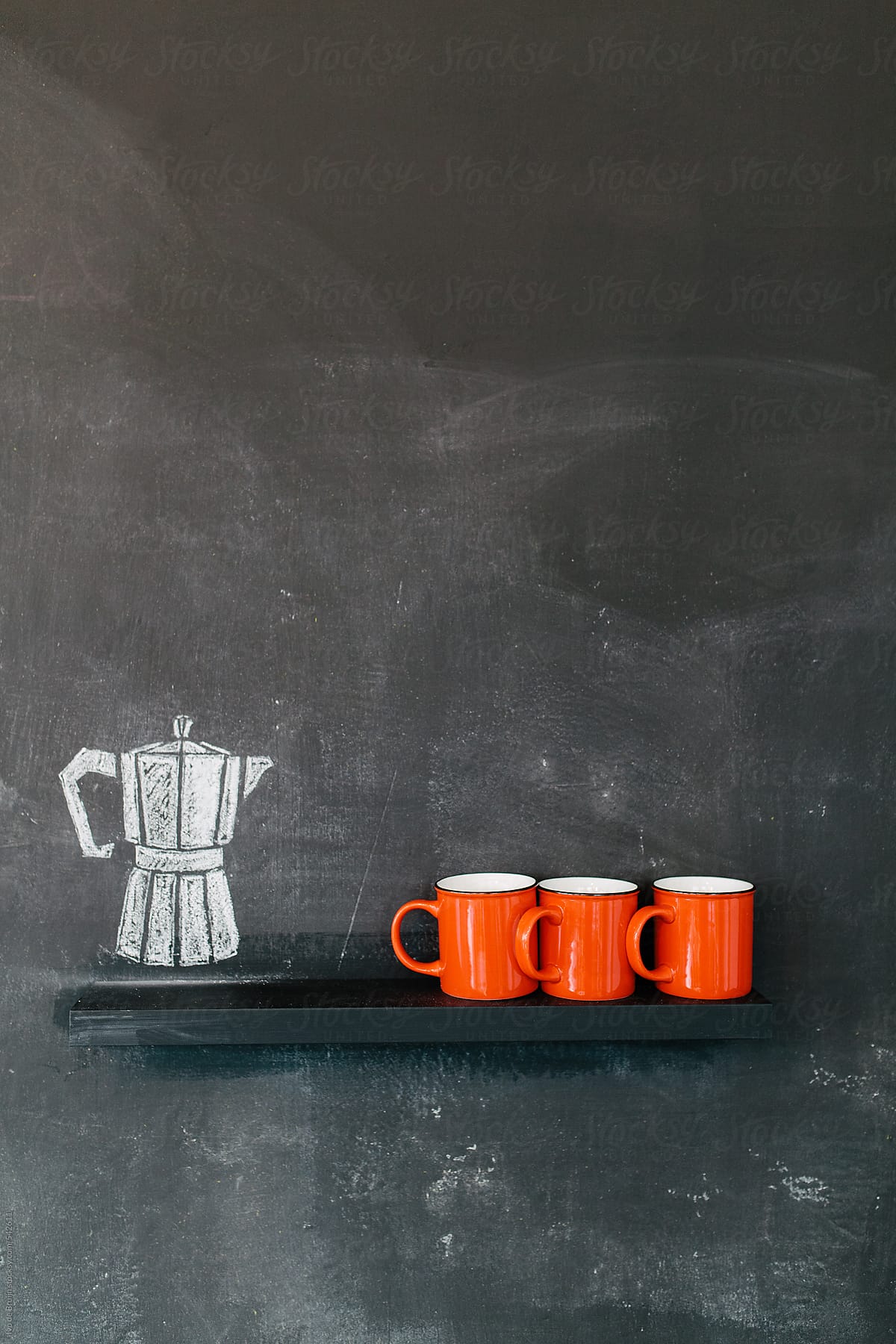 Photo of three red coffee cups with a drawn coffee pot next to it
