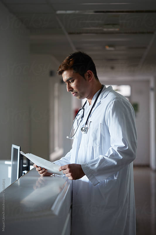 Portrait of a doctor reading a diagnosis in a hospital hall