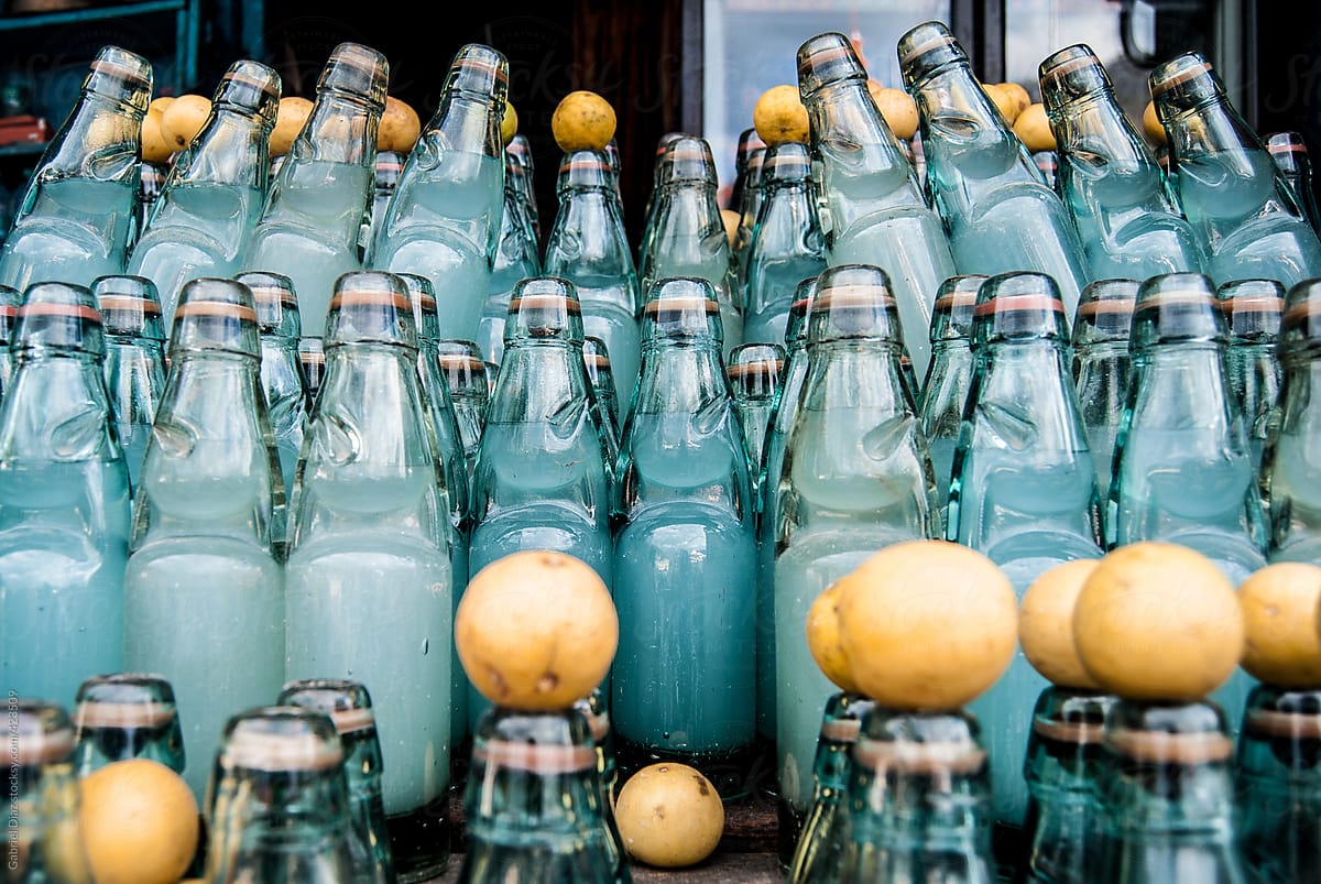 Close-up of Ramune soda bottles with lemons at a market stall