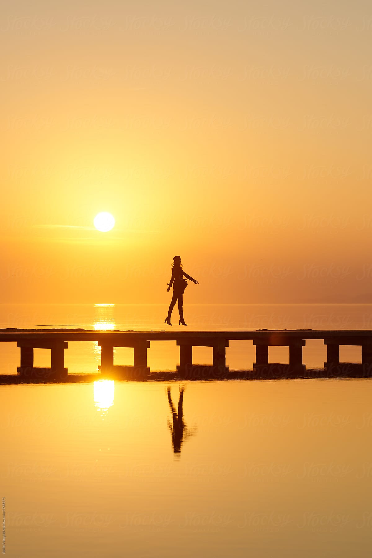 Dreaming person in sunset light on pier