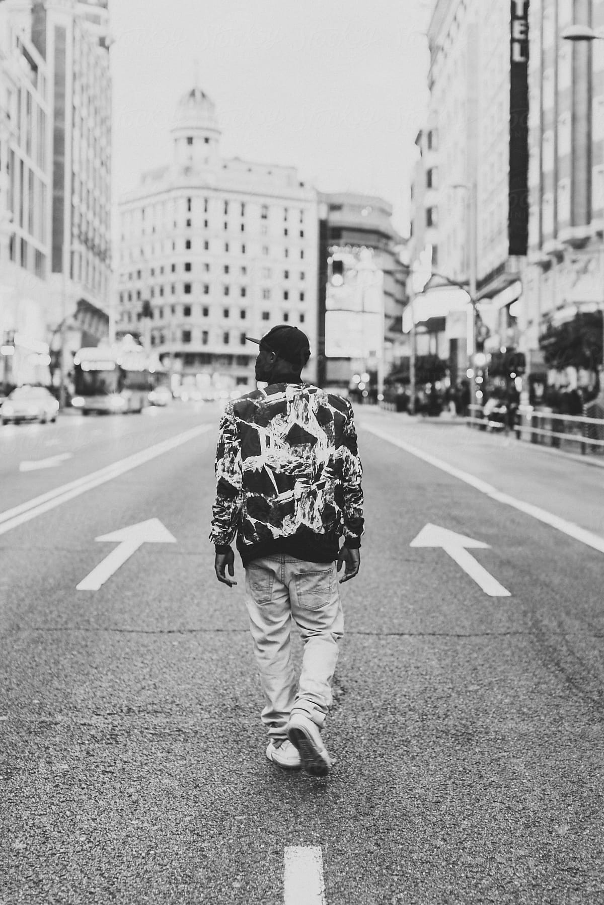 Young Black Man Walking Through an Urban Road