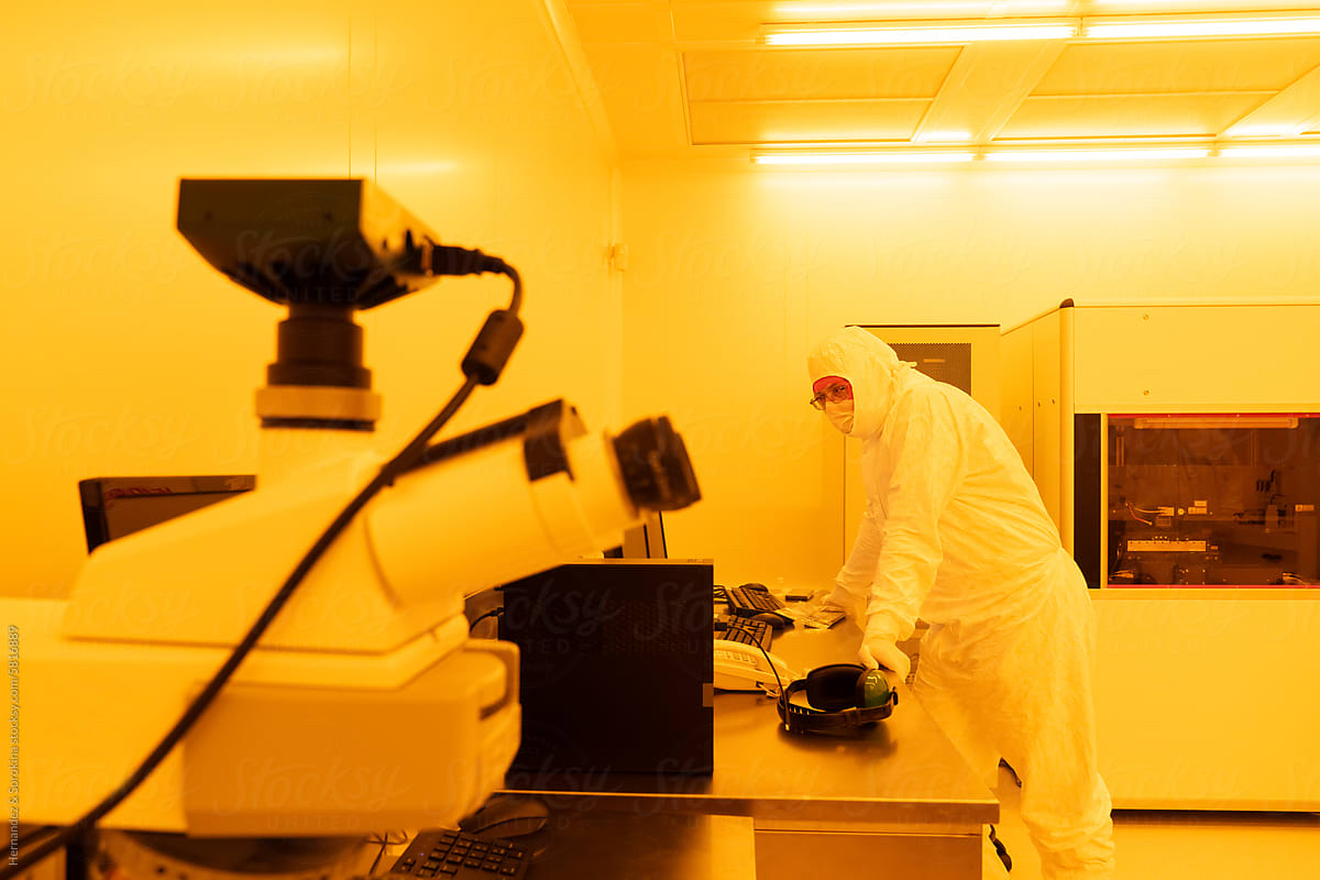 Scientist Working In Yellow Light Clean Room