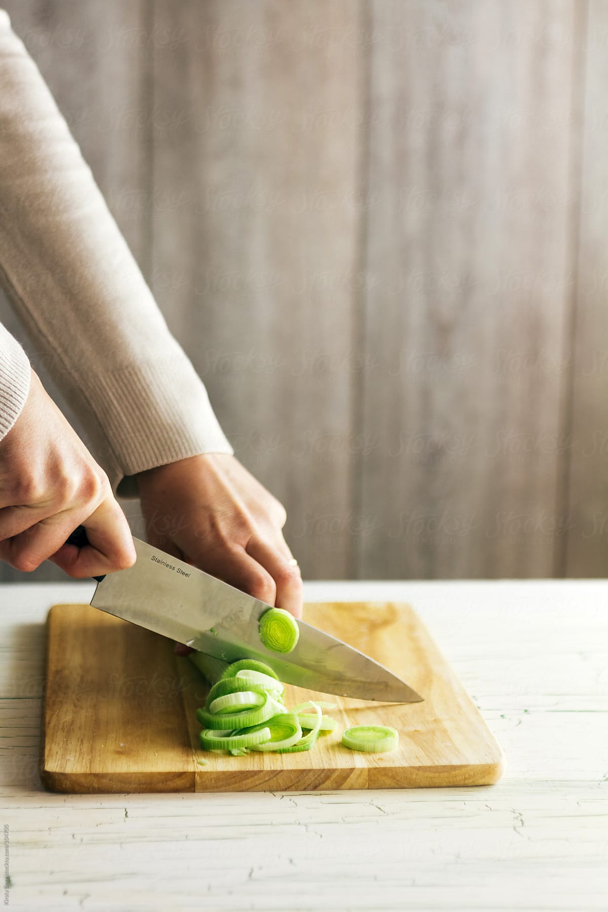Woman chopping leeks for soup