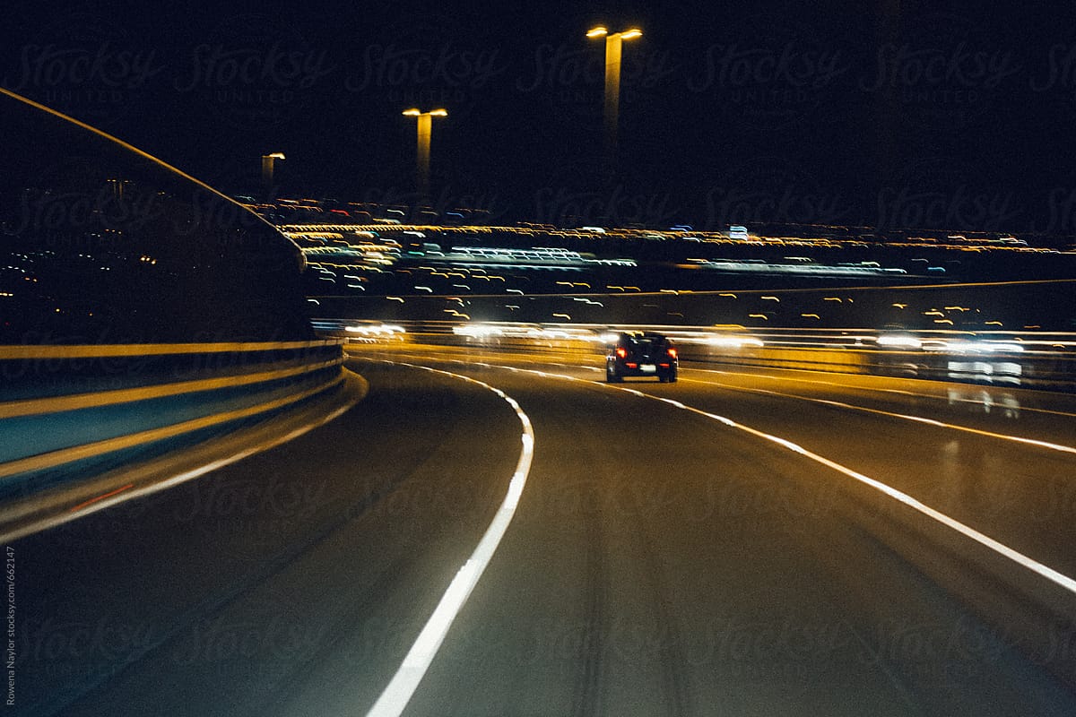 Speeding sports car on freeway at night