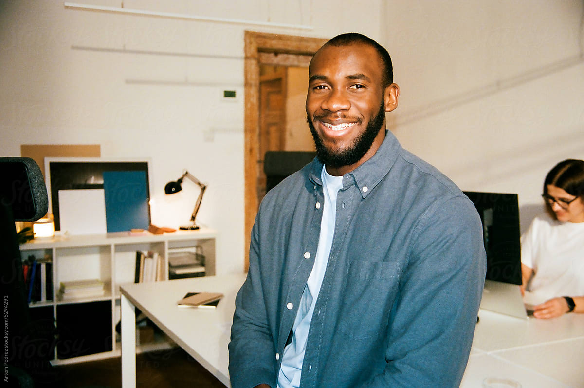 Film photo  Portrait of a young smiling man in a bright office