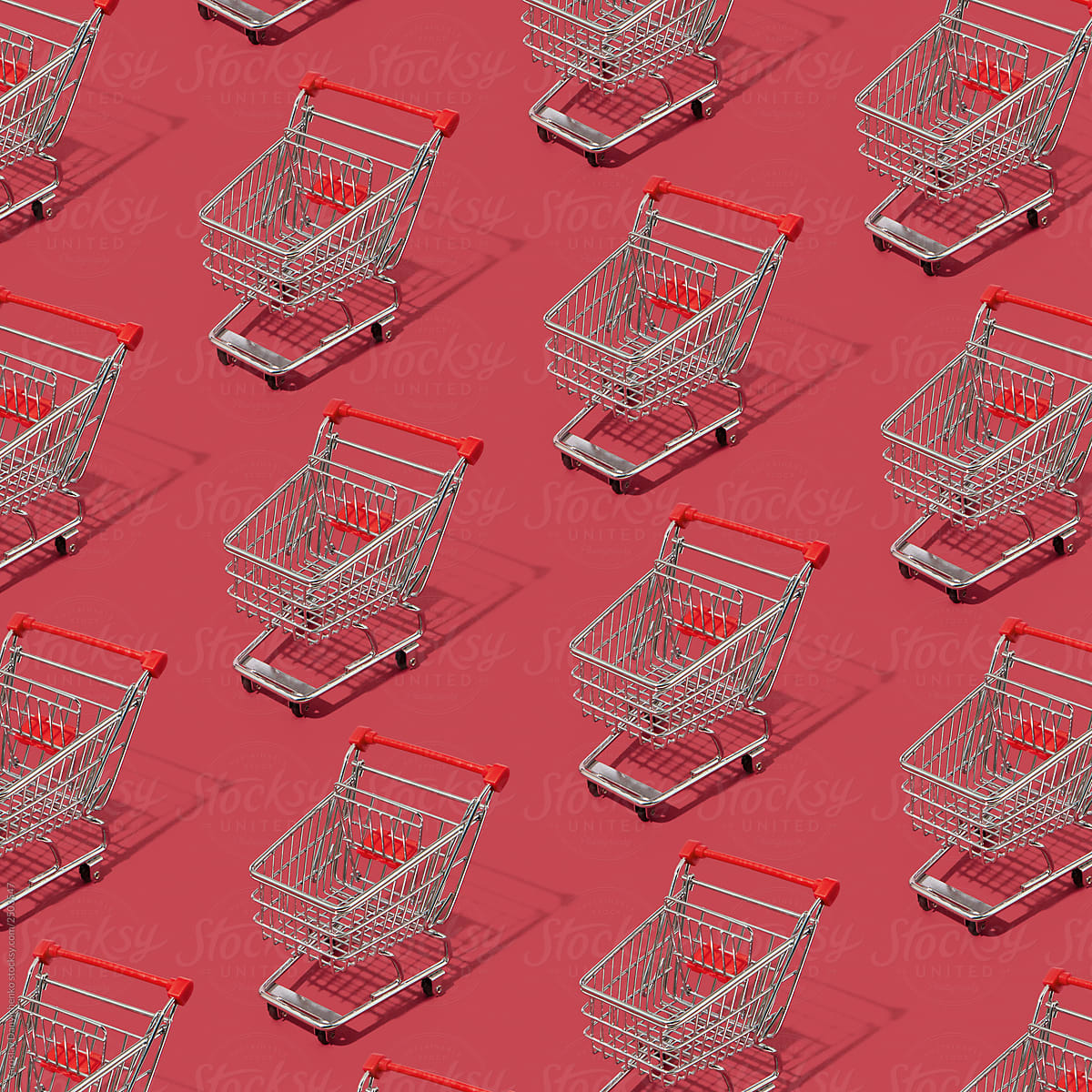 Many metal shopping carts on a red background with reflection of the shadows. Layout pattern with shopping concept. Flat lay