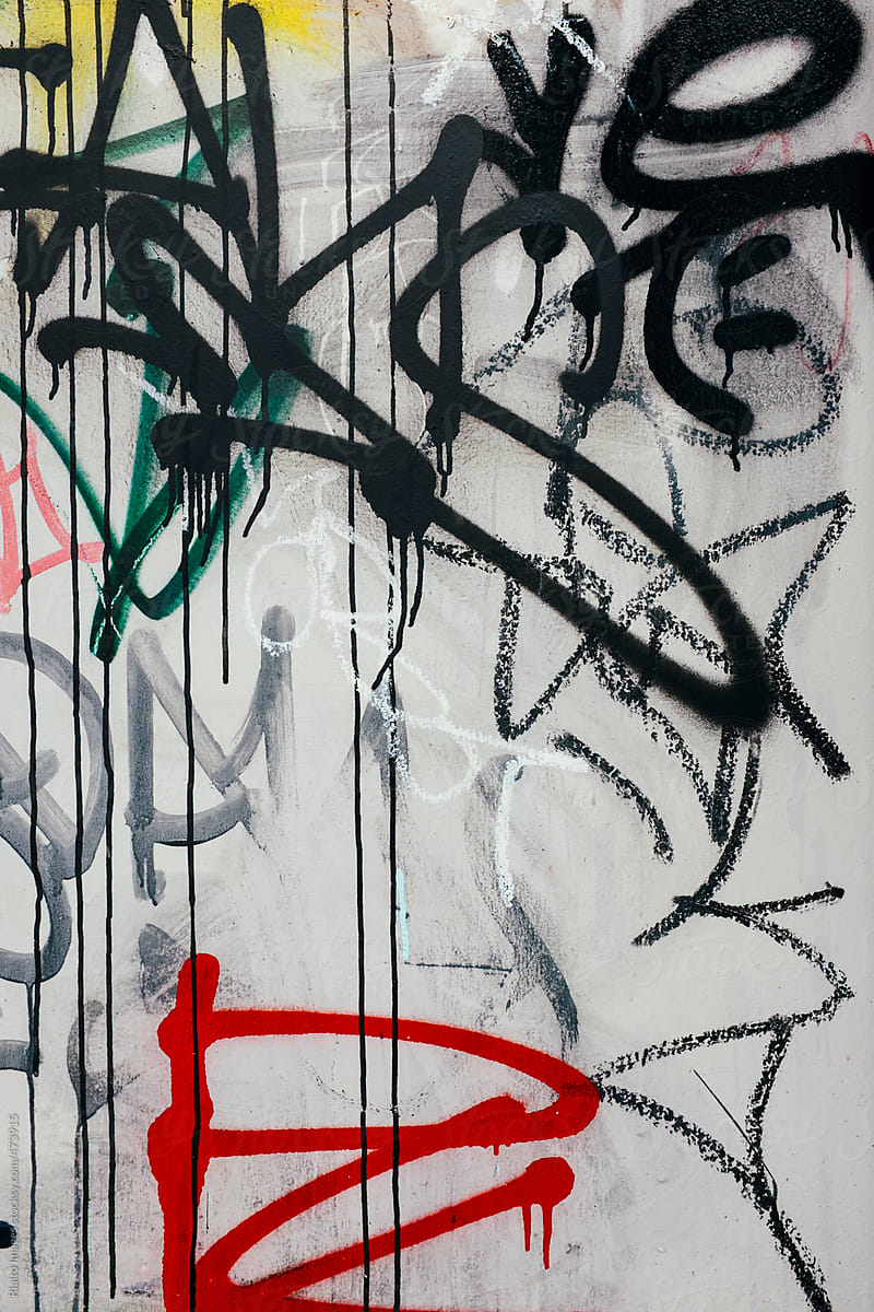 Graffiti painted on exterior of building wall, close up
