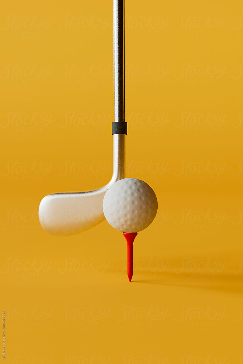 Golf Ball and Putter Alignment on Red Tee Against Yellow Backgro