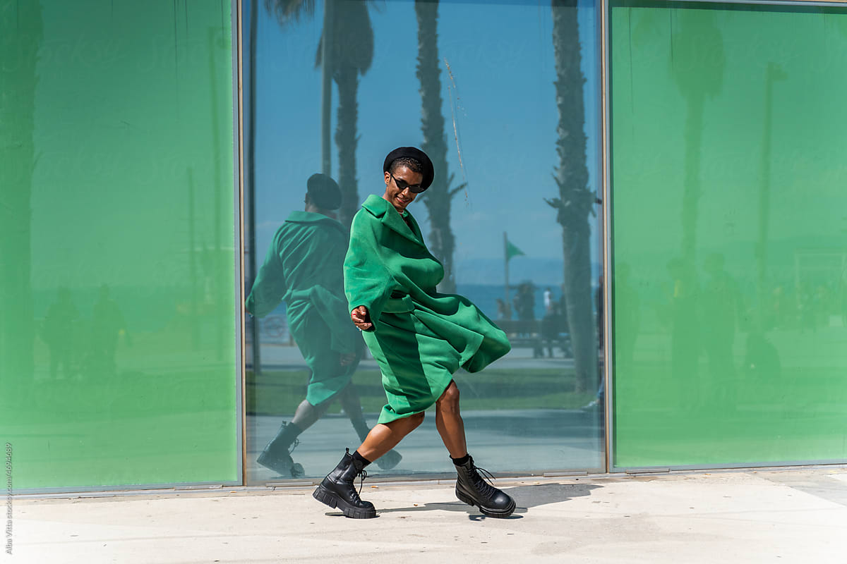 Stylish dancer in green outside building