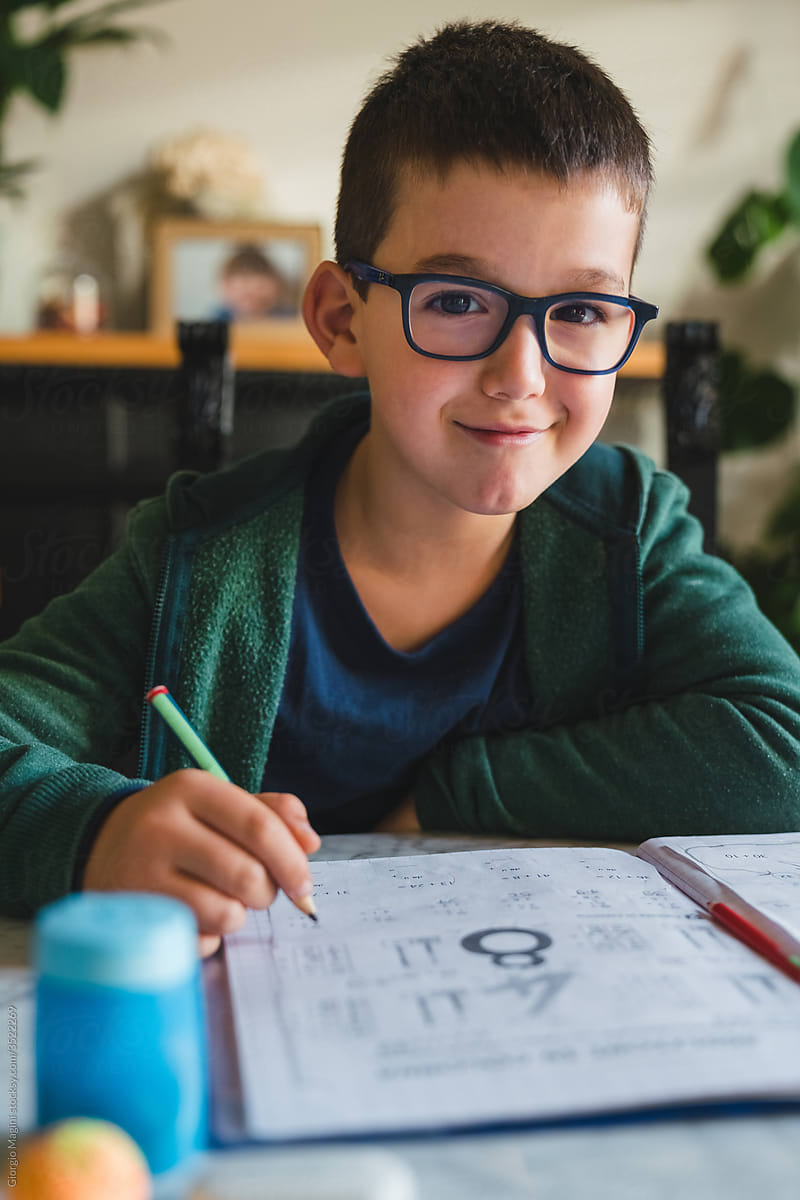 Portrait of a Child with Glasses doing Homework