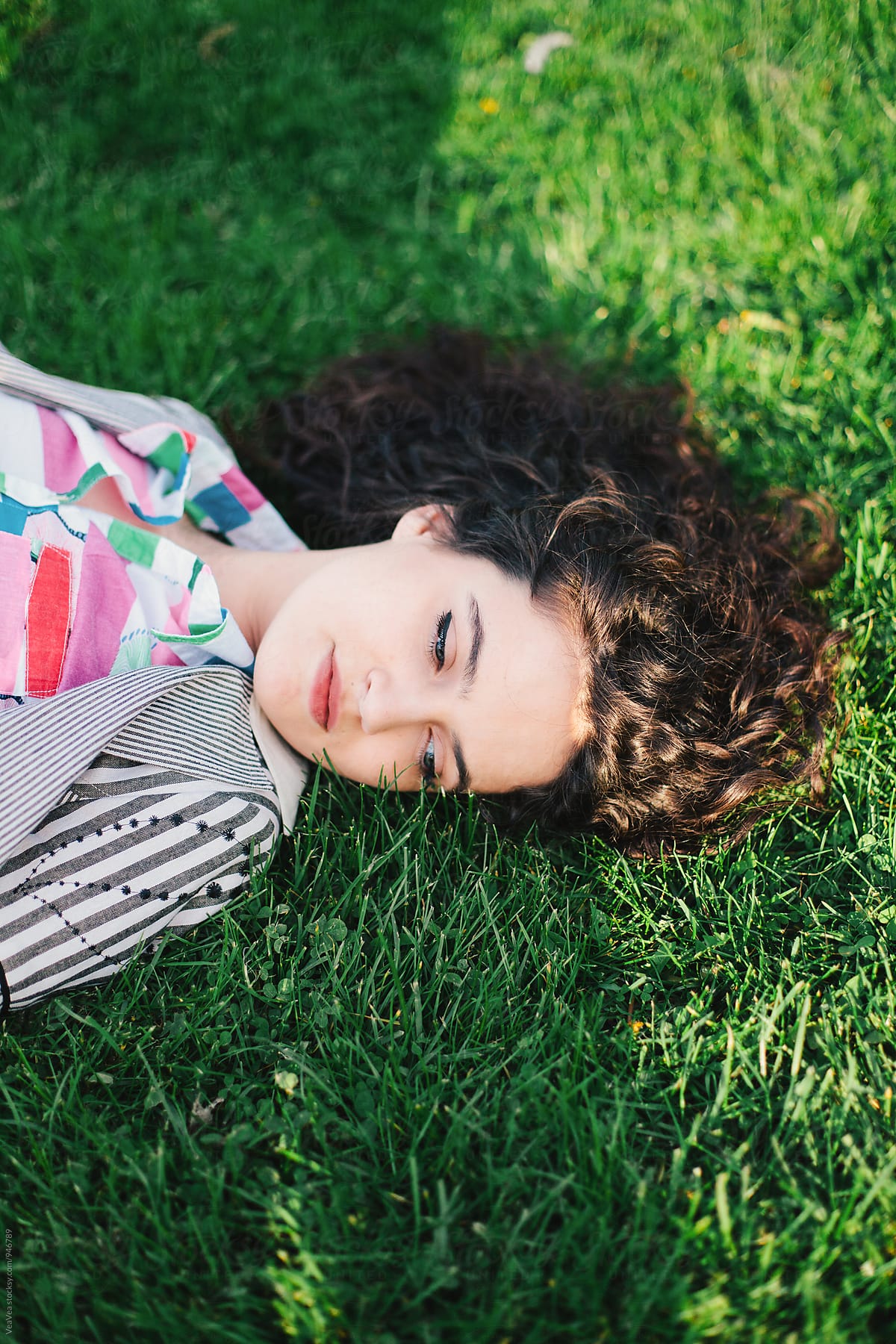 Woman Lying On Grass By Stocksy Contributor Mak Stocksy