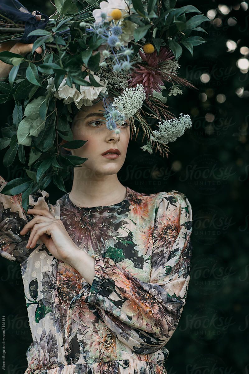 Model in dress with floral headwear